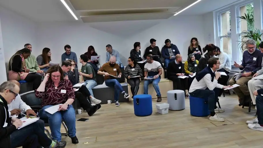 A group of participants sitting in a workshop space during an interactive OKR training session