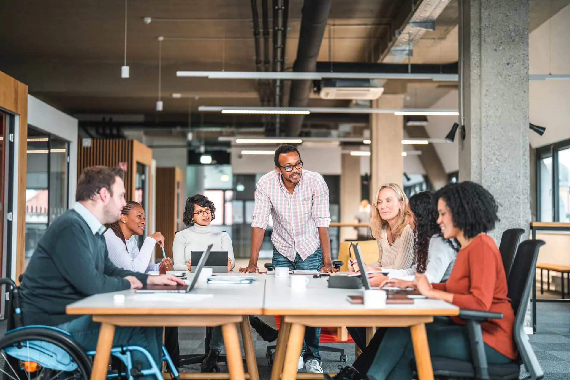 Diverse team collaborating in a modern workspace during an OKR consultancy session