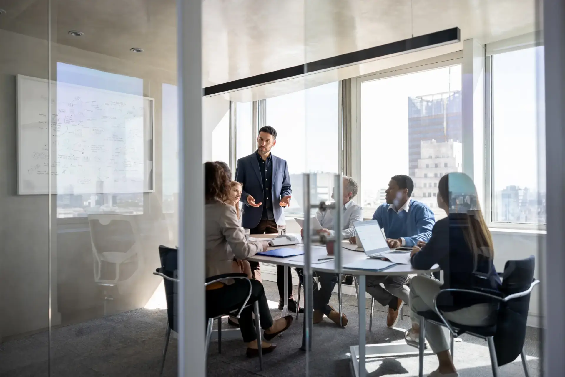 Business team in a strategy meeting ran by an OKR Consultant representing OKR consulting and collaboration
